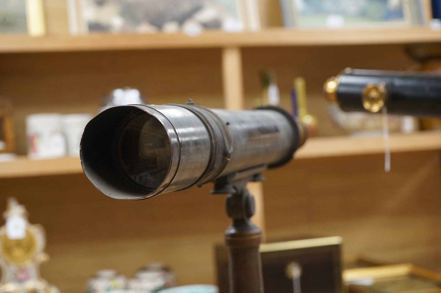 An early 20th century brass two draw telescope on tabletop tripod stand, with engraved dedication; ‘ Computed and Presented by J.W. Gifford. F.R.A.S. Chard 1917’, 73cm long, 48cm high on stand.